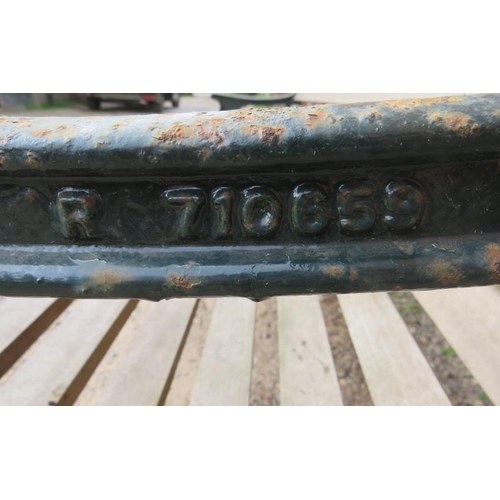 743 - A large cast iron park bench with teak slatted seat and heavy end supports depicting lions heads, vi... 