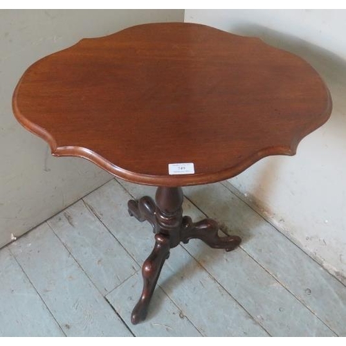 749 - A Victorian mahogany wine table with a shaped top over a balluster column and scrolled tripod feet.
... 