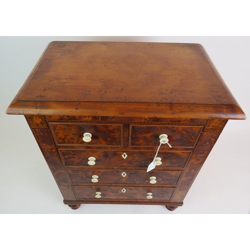 5 - A 19th Century apprentice cabinet of 5 drawers with bird's eye maple veneer finish and turned bone h... 