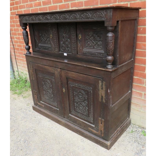 747 - An 18th century oak court cupboard of small proportions with carved frieze over two cupboard doors o... 