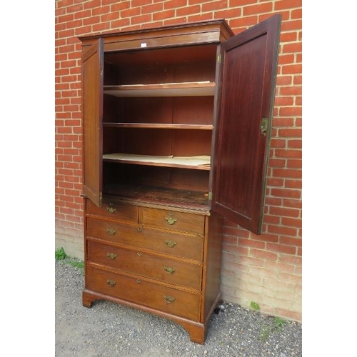 768 - A Georgian inlaid and crossbanded mahogany linen press, with three slides, over a chest base housing... 