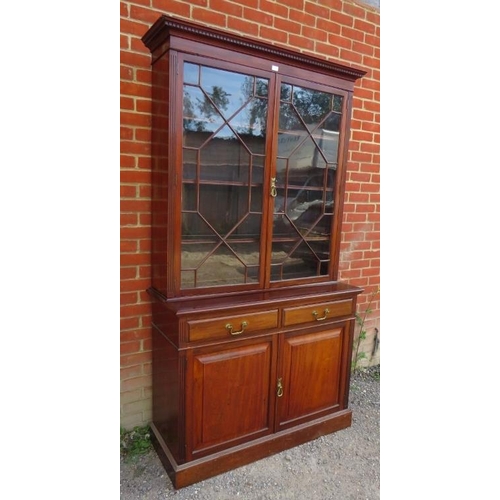 772 - An Edwardian mahogany tall bookcase with dentil cornice over astral glazed doors opening onto three ... 