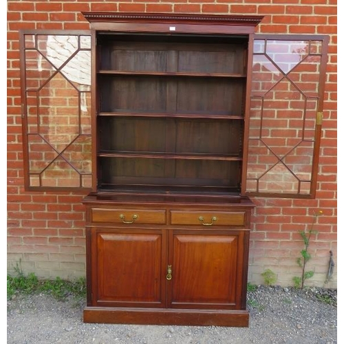 772 - An Edwardian mahogany tall bookcase with dentil cornice over astral glazed doors opening onto three ... 