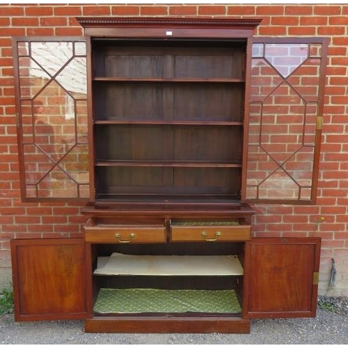 772 - An Edwardian mahogany tall bookcase with dentil cornice over astral glazed doors opening onto three ... 