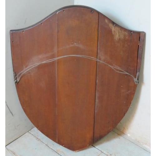 812 - An Edwardian shield shaped bevelled wall mirror, the mahogany frame strung with boxwood.
Condition r... 