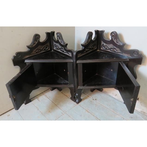 819 - A pair of 19th century ebonised wall hanging corner shelves with acanthus carved & scrolled cornices... 