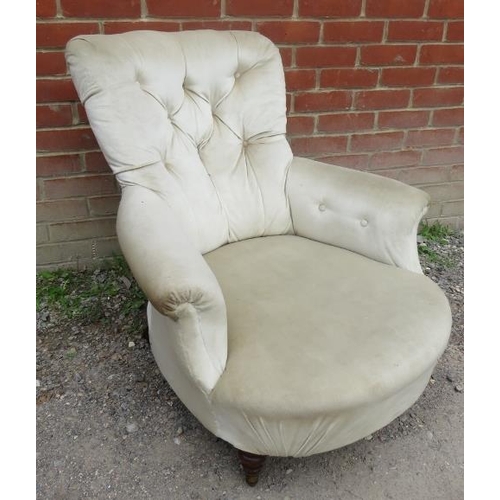 844 - A Victorian low bedroom armchair upholstered in a cream buttoned velvet, raised on tapering turned s... 