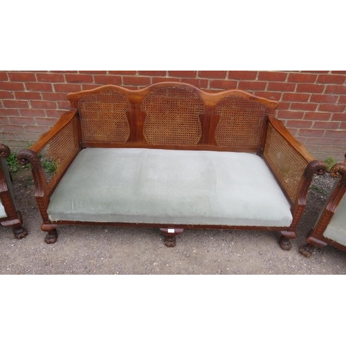 895 - A Victorian mahogany three piece suite with bergere back and side panels and ornately carved swan he... 