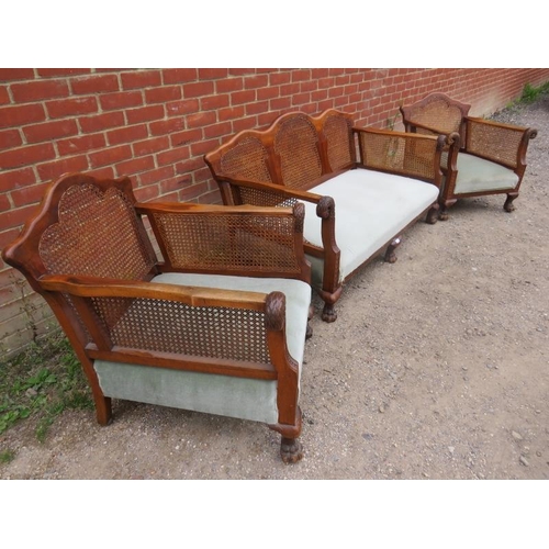 895 - A Victorian mahogany three piece suite with bergere back and side panels and ornately carved swan he... 