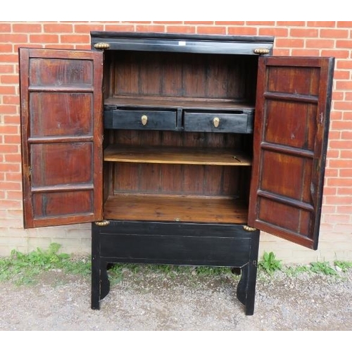 899 - A Chinese black lacquered elm marriage cabinet, the double doors opening to reveal three shelves, th... 