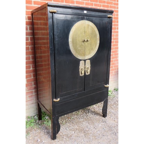 899 - A Chinese black lacquered elm marriage cabinet, the double doors opening to reveal three shelves, th... 