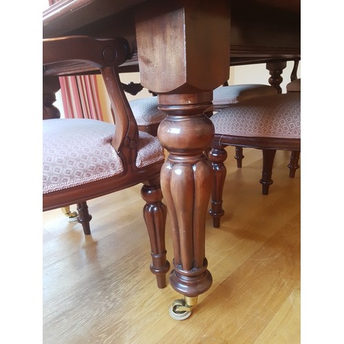 900 - A solid mahogany reproduction Victorian style extending dining table raised on fluted legs with cast... 