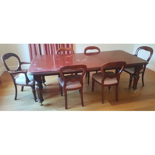 900 - A solid mahogany reproduction Victorian style extending dining table raised on fluted legs with cast... 