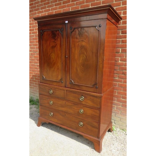 720 - A Georgian mahogany linen press with parquetry inlaid cornice over a two double doors opening onto h... 