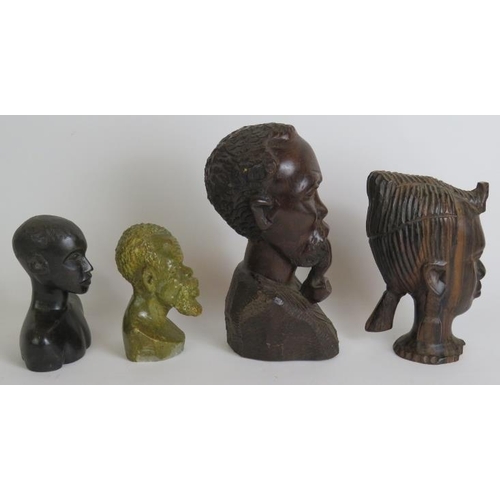 105 - Four decorative carved African tribal busts, three fashioned from hardwood and one from stone. Circa... 