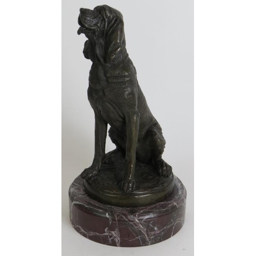 107 - A contemporary bronze figure of a sitting bloodhound dog mounted on a red marble base, signed PJ Men... 