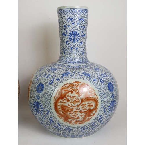 11 - A pair of large Chinese porcelain 'Tianqiuping' bottle vases, probably 20th Century each decorated i... 