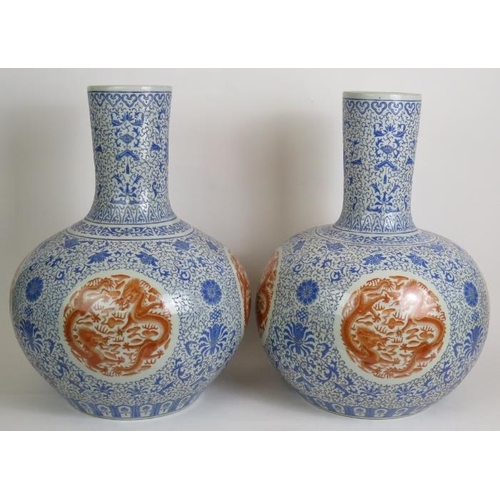 11 - A pair of large Chinese porcelain 'Tianqiuping' bottle vases, probably 20th Century each decorated i... 