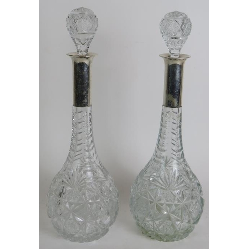 111 - A pair of German cut crystal decanters by Wilkens Und Sohn with German silver marked collars, plus a... 