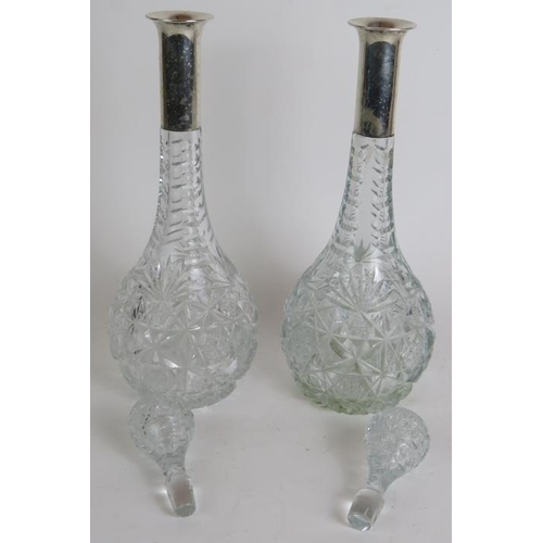 111 - A pair of German cut crystal decanters by Wilkens Und Sohn with German silver marked collars, plus a... 