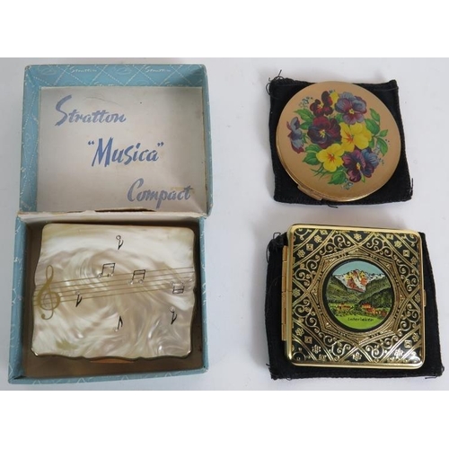 116 - Two vintage Stratton powder compacts, one musical, a similar compact with a view of interlaken and a... 