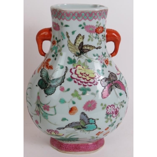 12 - An antique Chinese porcelain vase richly enamel decorated with butterflies and flowers. Seal mark to... 