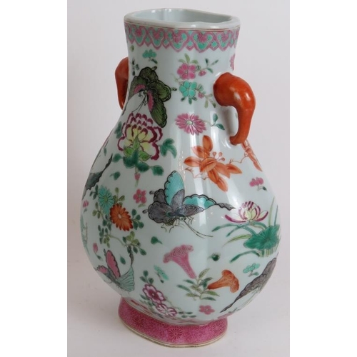 12 - An antique Chinese porcelain vase richly enamel decorated with butterflies and flowers. Seal mark to... 