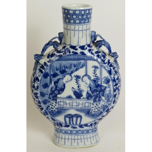 13 - An antique Chinese porcelain moon vase decorated in blue and white with applied dragon handles and f... 