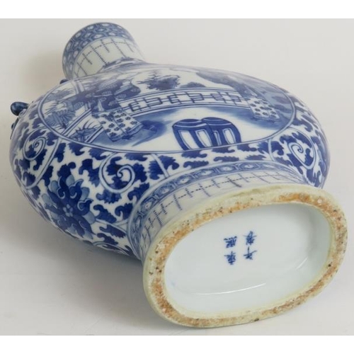 13 - An antique Chinese porcelain moon vase decorated in blue and white with applied dragon handles and f... 