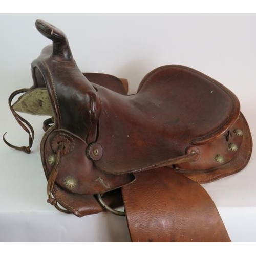 131 - A vintage leather American Simco saddle with wooden stirrups stamped Simco 7100.
Condition report: V... 