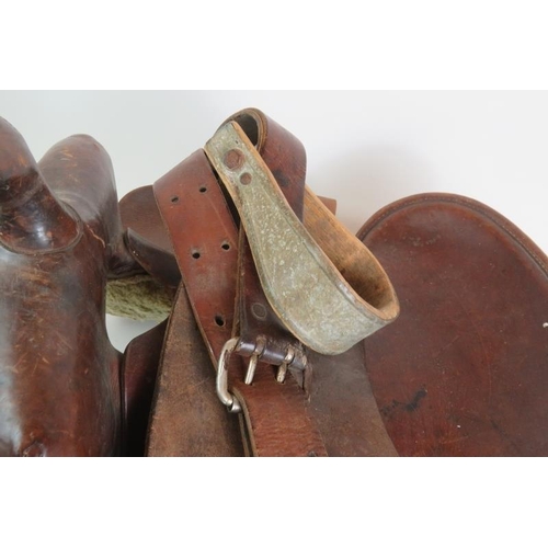 131 - A vintage leather American Simco saddle with wooden stirrups stamped Simco 7100.
Condition report: V... 