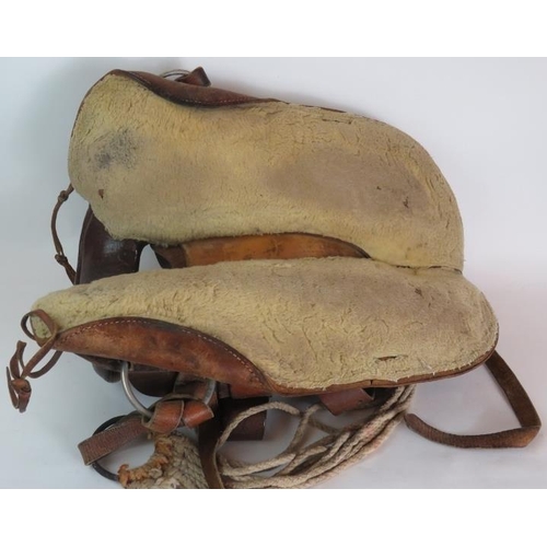 131 - A vintage leather American Simco saddle with wooden stirrups stamped Simco 7100.
Condition report: V... 