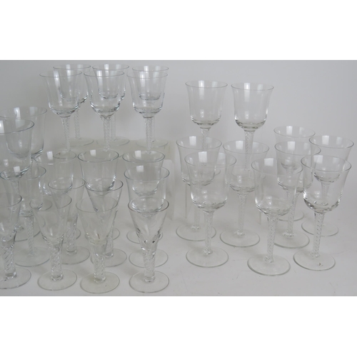 154 - A suite of 38 contemporary air twist drinking glasses to include 11 red wine, 10 white wine, 11 sher... 