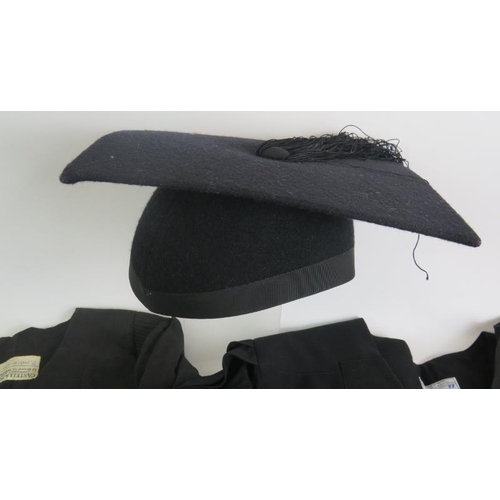 157 - Two black graduation gowns and a mortar board size 6 5/8. (5).
Condition report: No issues.