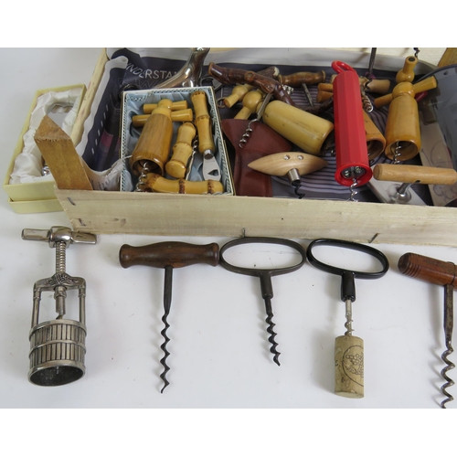 166 - A collection of vintage corkscrews and bottle openers of varying types including a 1960s bamboo hand... 