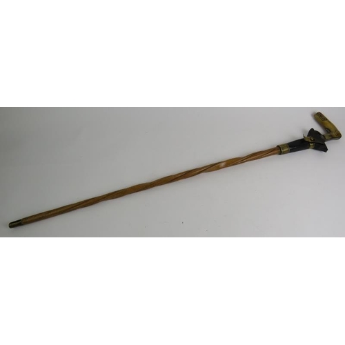 21 - An antique Wrythen shafted walking stick with percussion muff pistol handle, c1820. The octagonal ba... 