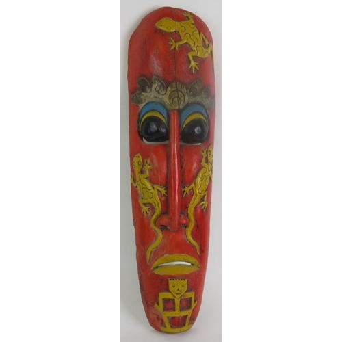 3 - A hand carved Indonesian tribal mask with aged painted decoration and slit cut eye and mouth holes. ... 