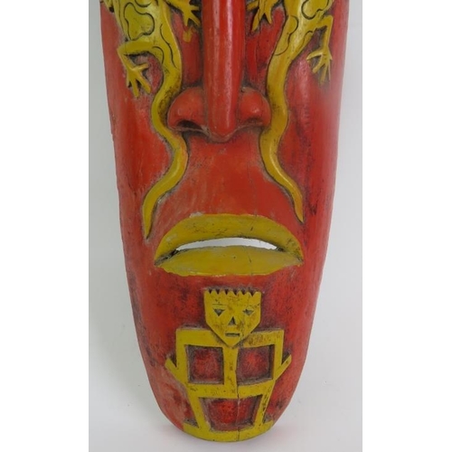 3 - A hand carved Indonesian tribal mask with aged painted decoration and slit cut eye and mouth holes. ... 