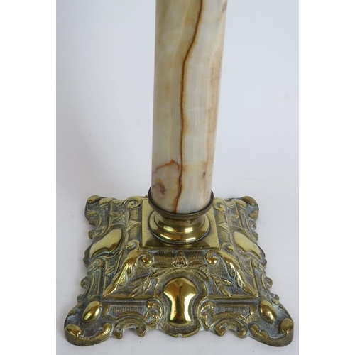 37 - A tall antique oil lamp standing on a white onyx and brass Corinthian column base with oilive cut cl... 