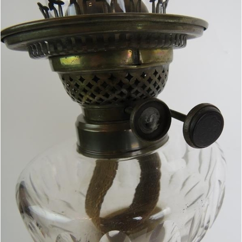 37 - A tall antique oil lamp standing on a white onyx and brass Corinthian column base with oilive cut cl... 