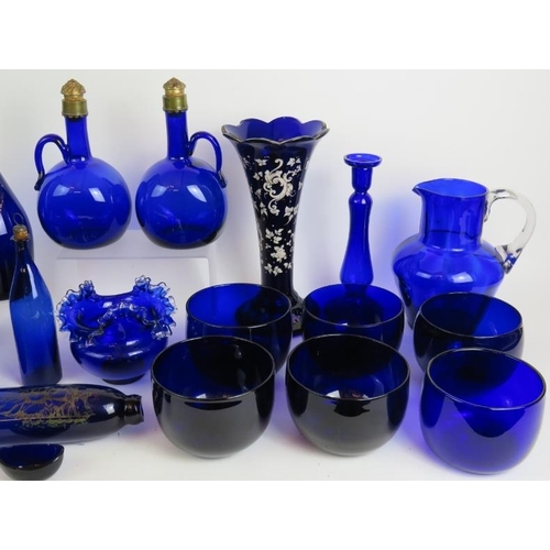 38 - 22 pieces of mainly antique Bristol blue glass including 2 gilded decanters, a decorated rolling pin... 