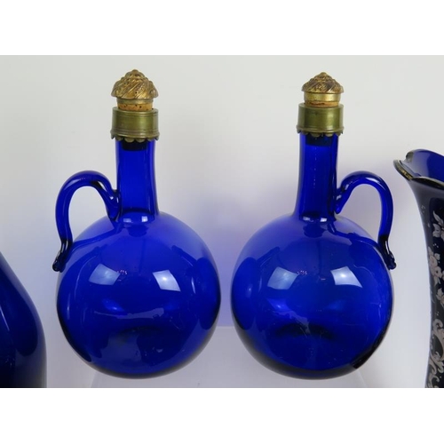 38 - 22 pieces of mainly antique Bristol blue glass including 2 gilded decanters, a decorated rolling pin... 