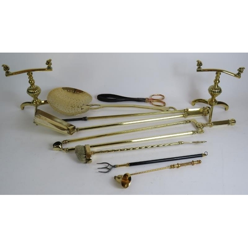 39 - An assortment of mainly antique brassware including a stick stand fire irons and andirons, toasting ... 