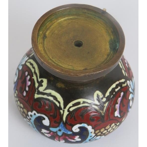 46 - An antique bronze inkwell decorated with champlevé enamelled scrollate motifs. Height 7.5cm.
Conditi... 