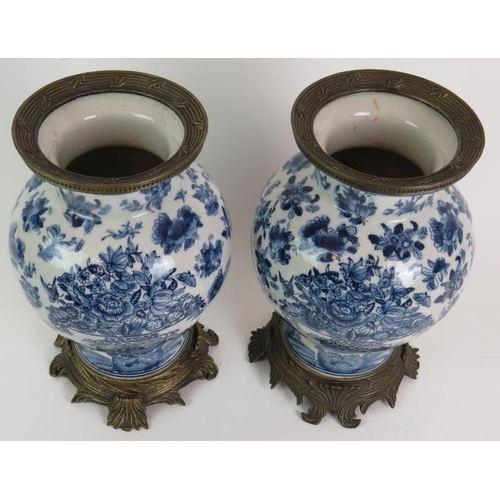 52 - A pair of decorative blue and white porcelain balluster vases with bronze metal mounts, probably 20t... 