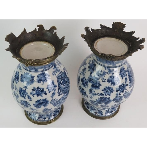 52 - A pair of decorative blue and white porcelain balluster vases with bronze metal mounts, probably 20t... 