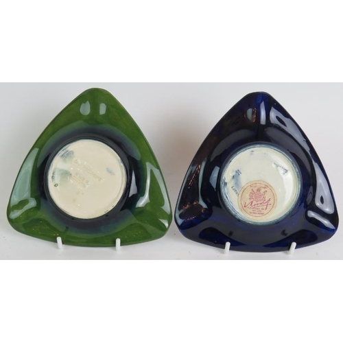 53 - A Moorcroft pottery hibiscus pattern table lighter and two similar triangular ash trays, one bearing... 