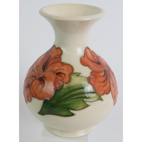 54 - A Moorcroft hibiscus pattern baluster vase 13.5cm, two similar blue hibiscus pattern pin dishes and ... 