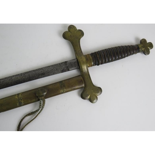 60 - An antique masonic sword with etched blade gilt brass hilt and wire bound leather grip, in a gilt mo... 