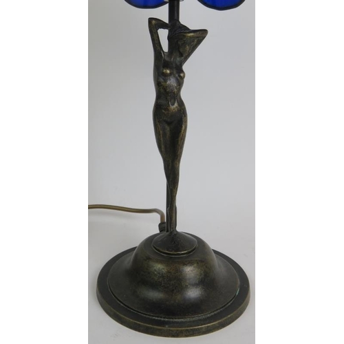 67 - A Tiffany style table lamp with bronze nude under a blue glass petal shaped shade. Overall height 47... 